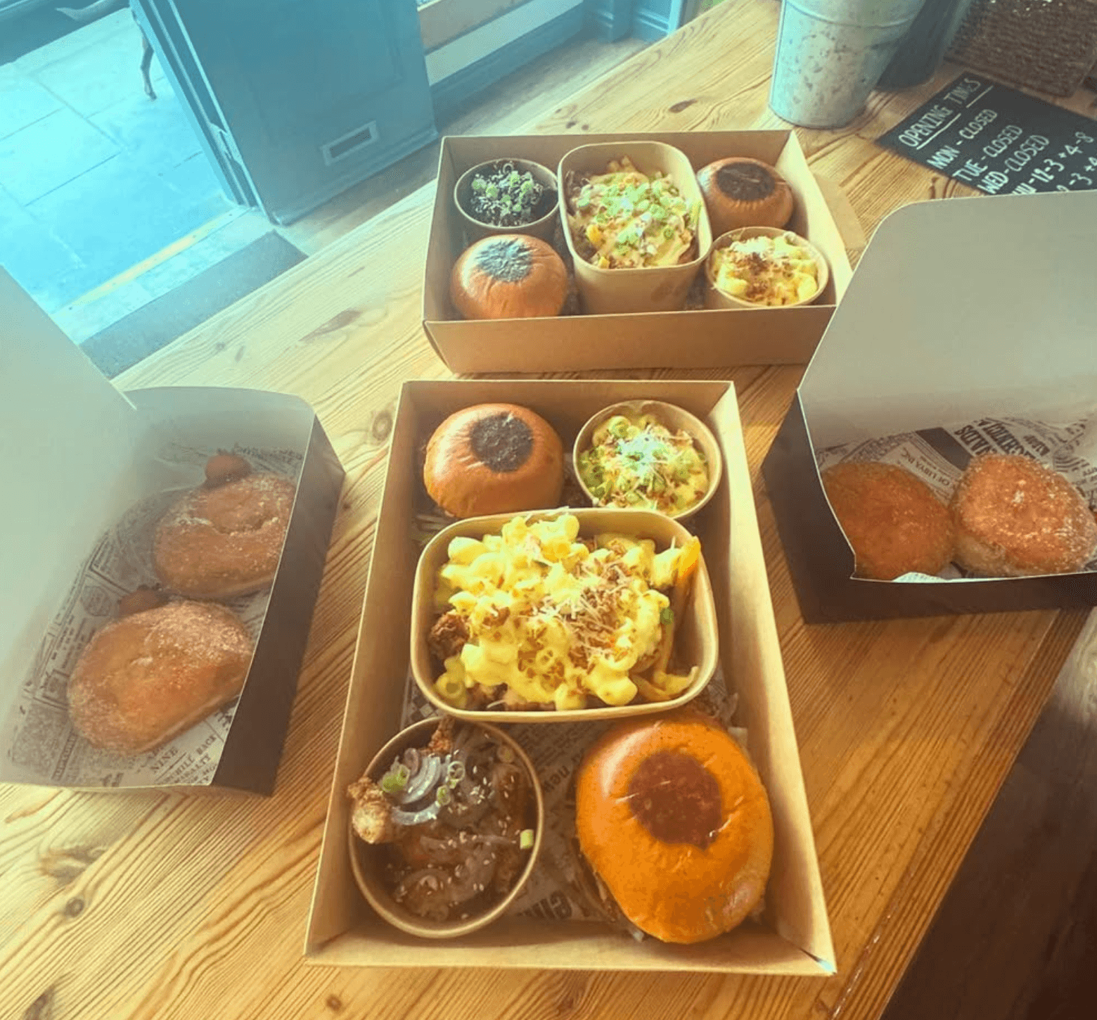 Box meals with burgers, mac and donuts