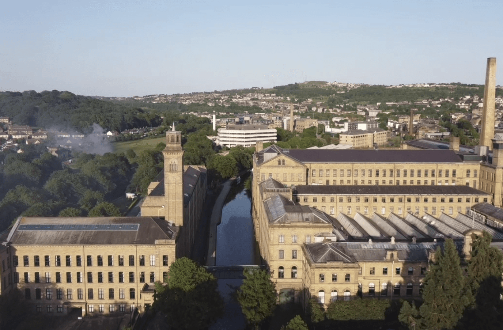 Historic mill building with tall chimney